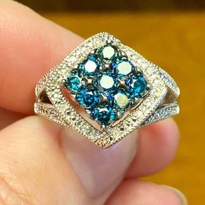 Beautiful light sapphire cluster ring, surrounded by tiny diamonds.